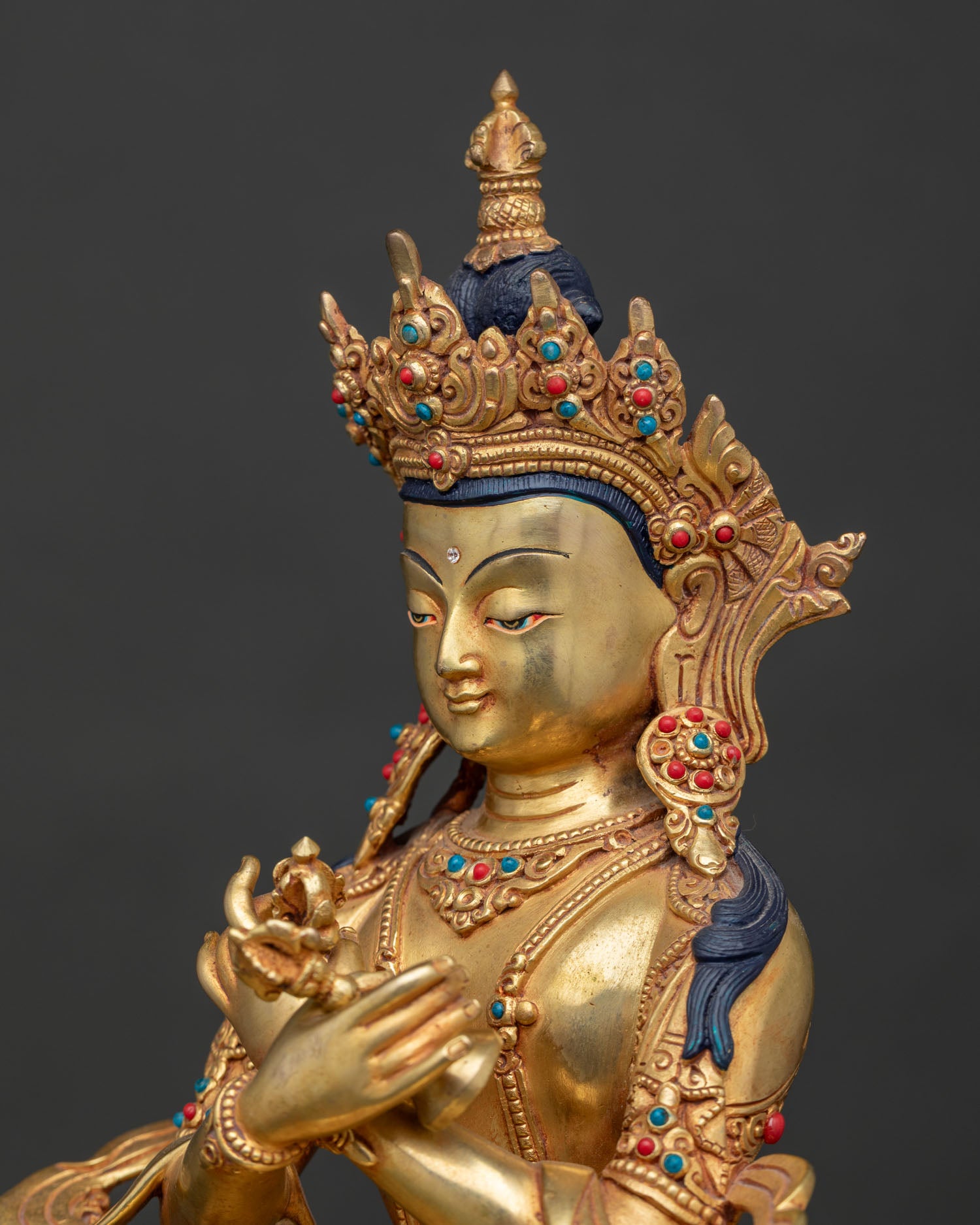 detailed side close up of vajradhara statue with hand chased copper details