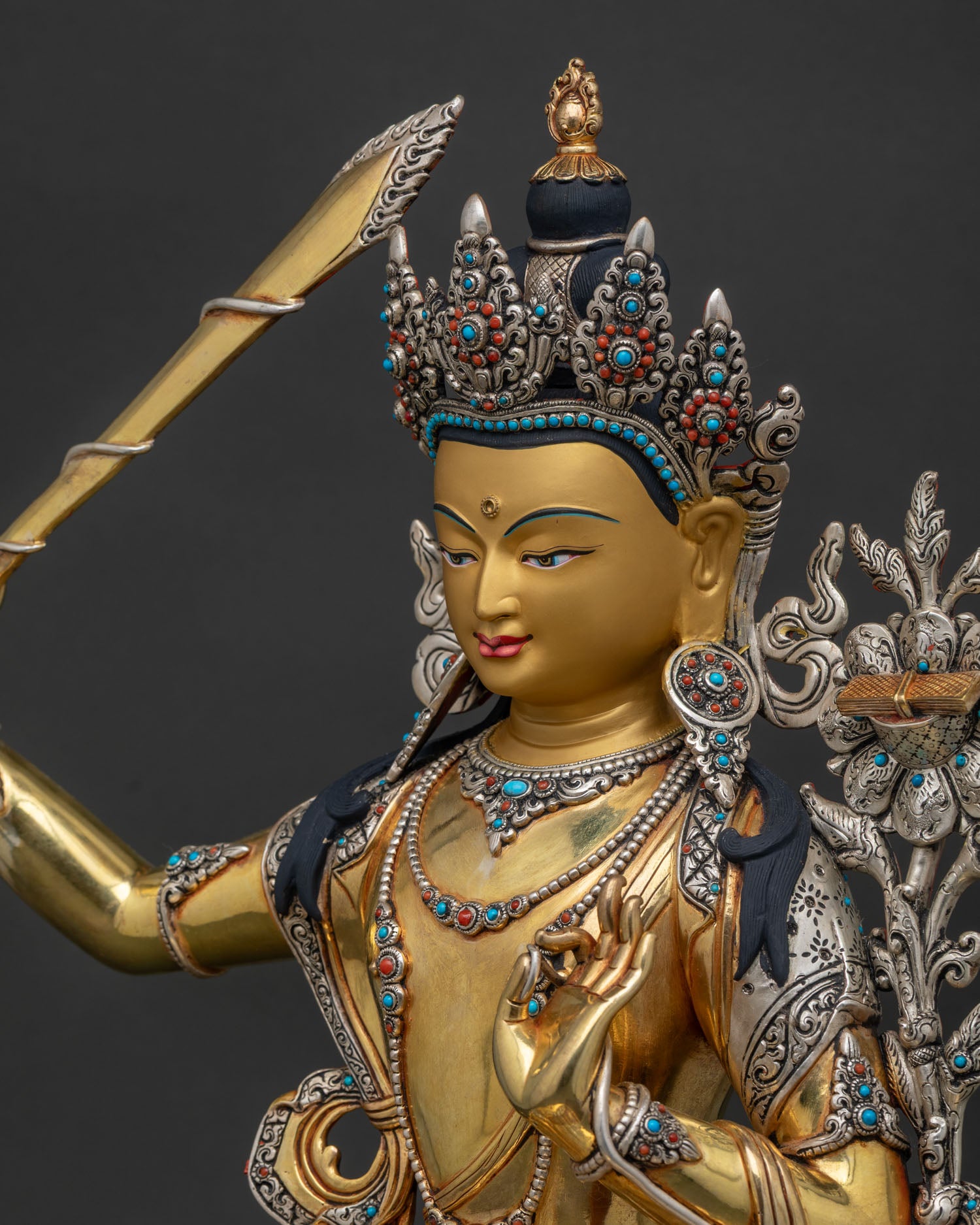 Detailed Side close up of Manjushri Statue showing silver plating and hand engraved details