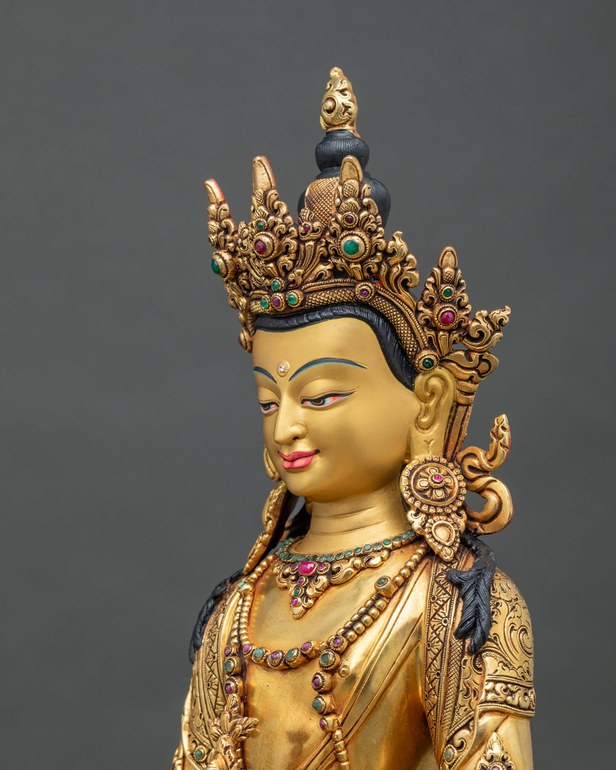 Detailed side close up of Amitayus Buddha statue with hand-carved robes and gold fire-gilding