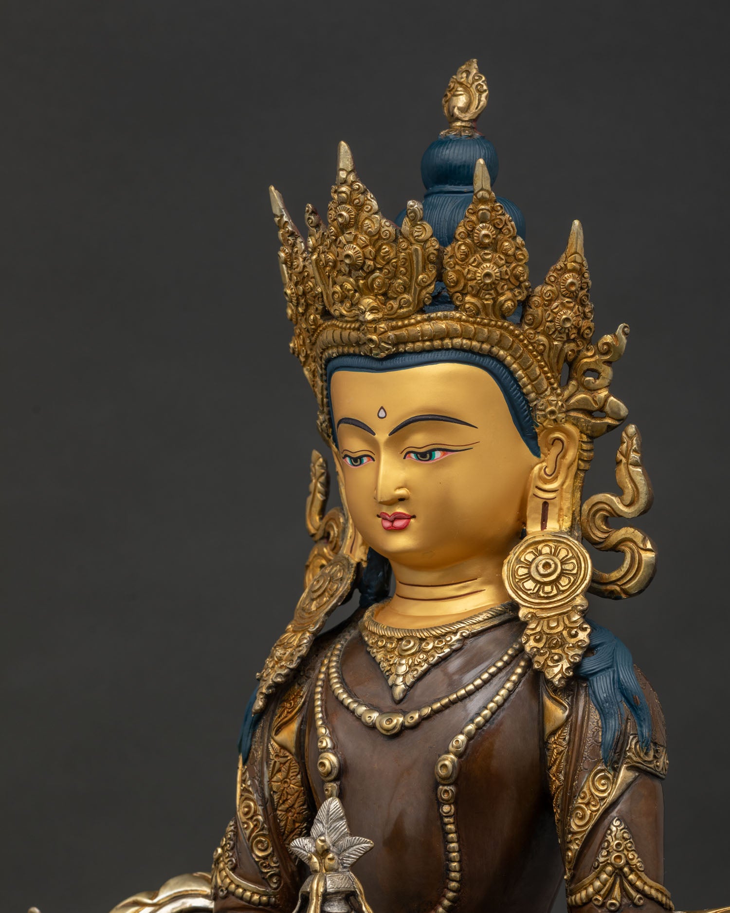 detailed side close up of amitayus statue with intricate chased copper craftsmanship