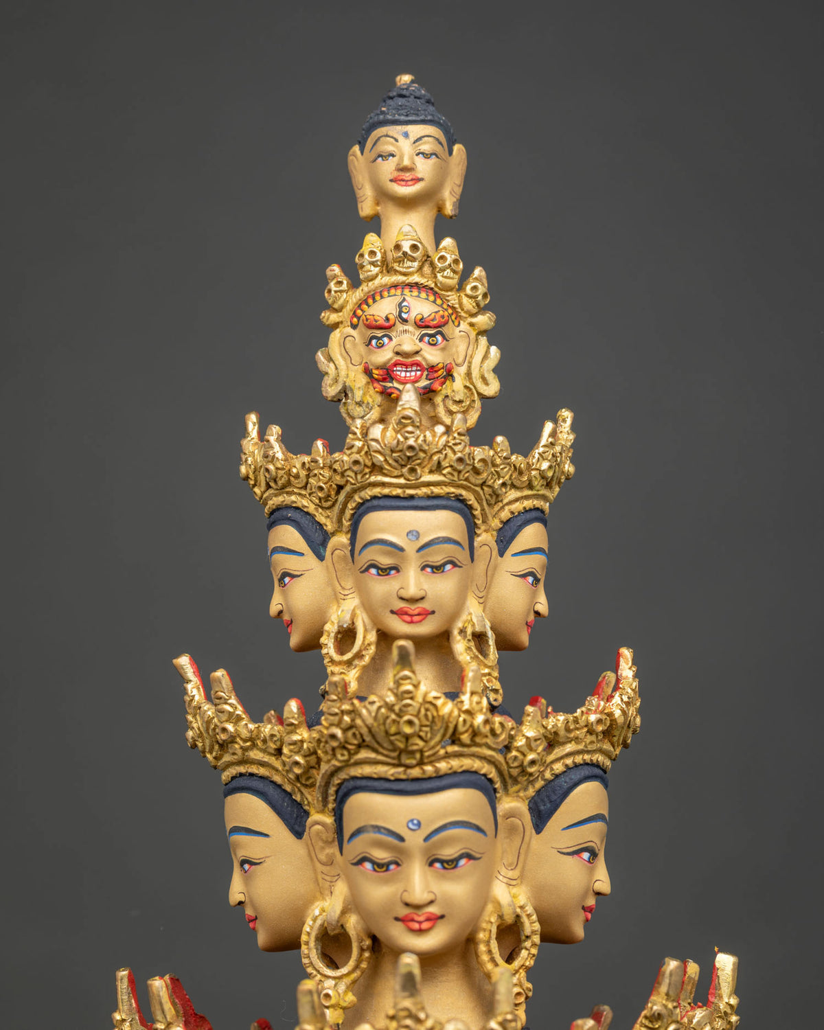 Detailed side close up of Avalokiteshvara statue arms with palm eyes and ritual bell, 24K gold gilded