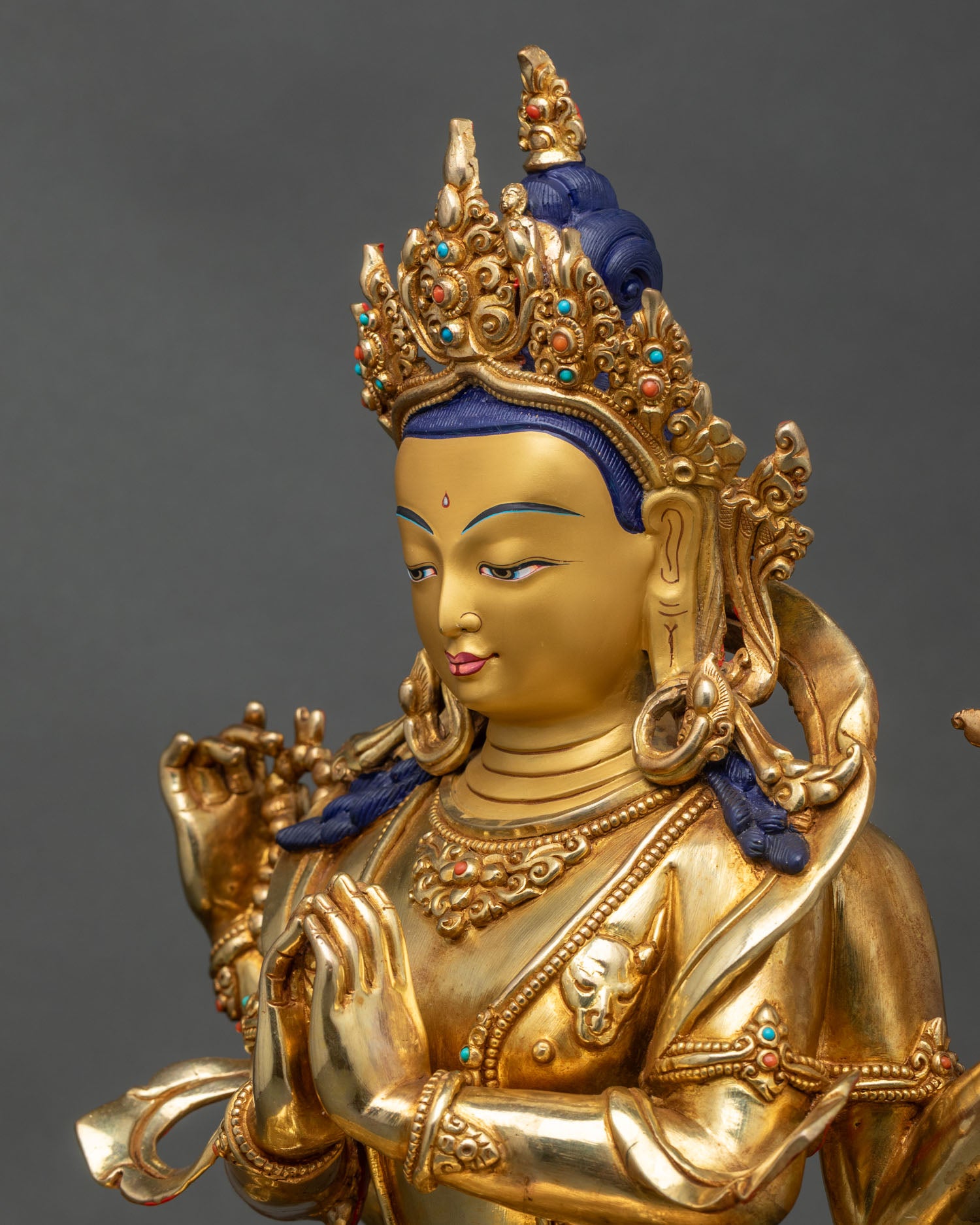 Detailed side close-up of Chenrezig statue, copper craftsmanship with lotus and crystal rosary