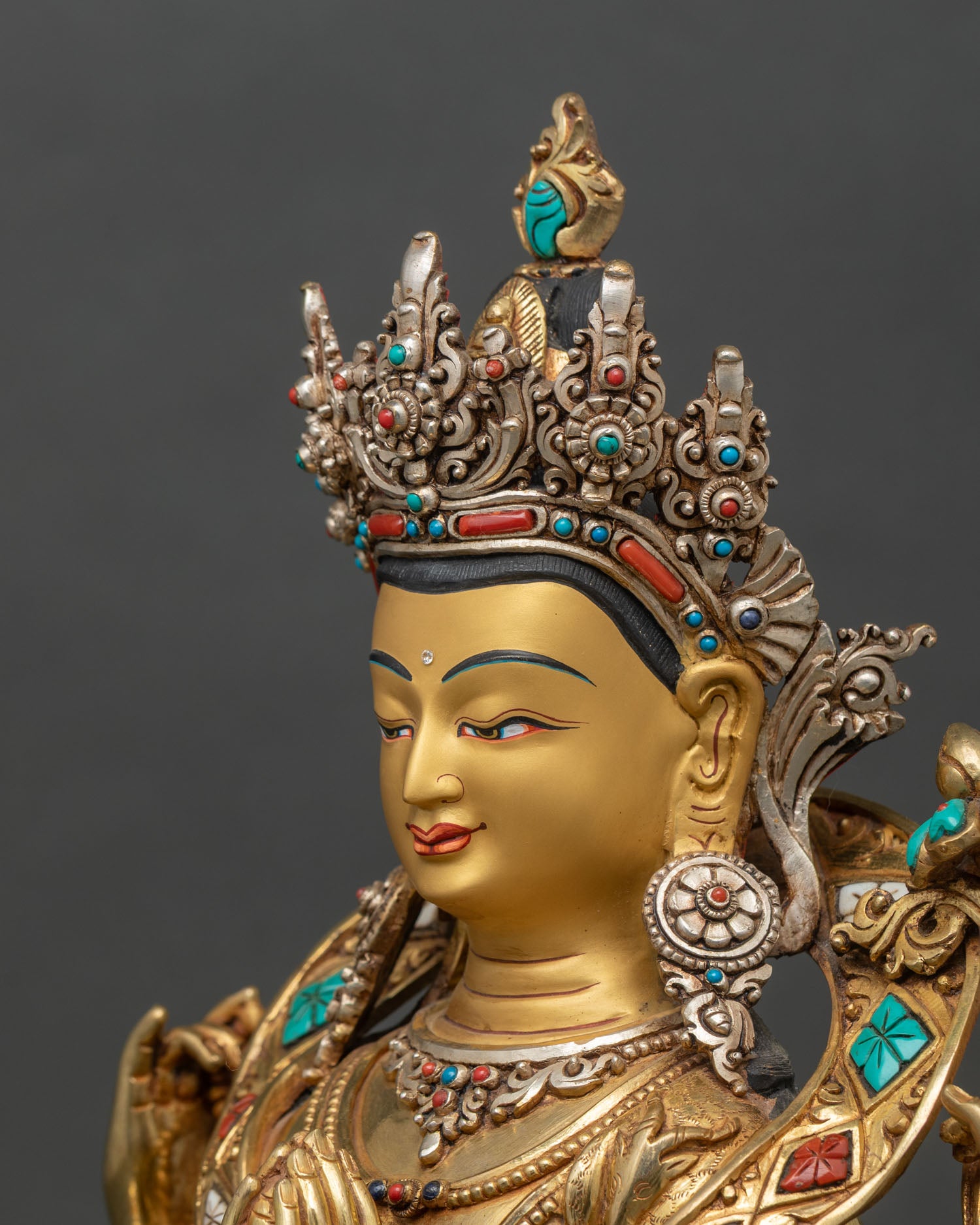 Detailed side close-up of Chenrezig Statue, showing sacred objects and lotus pedestal