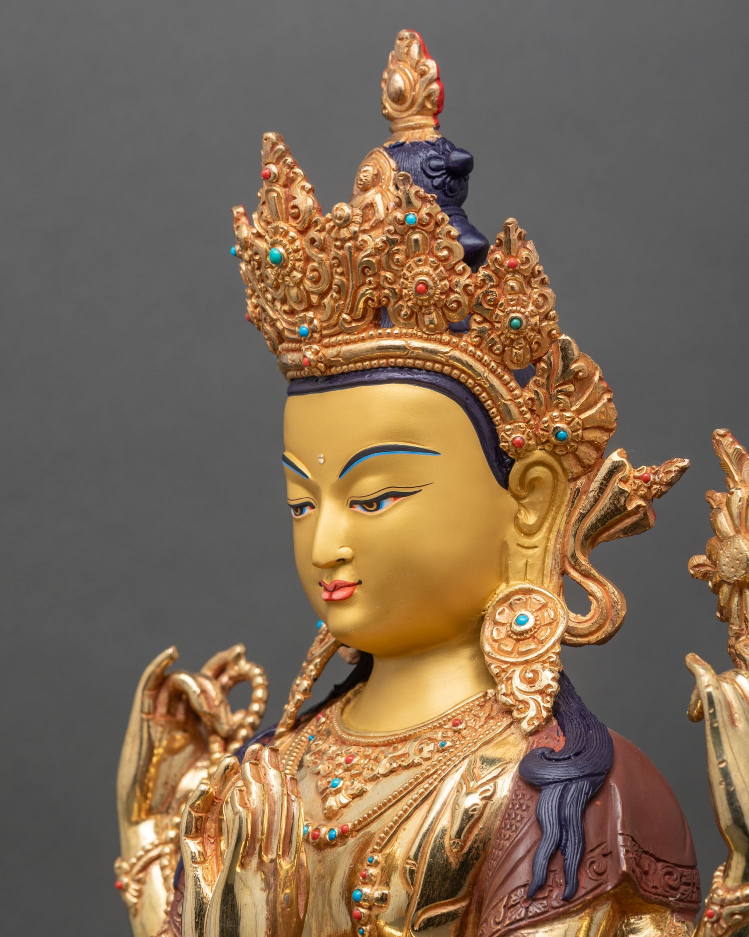 detailed side close up of chenrezig statue with lotus flower and turquoise coral inlays