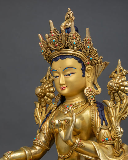 detailed side close-up of green tara statue showing lotus carvings and sacred ornaments