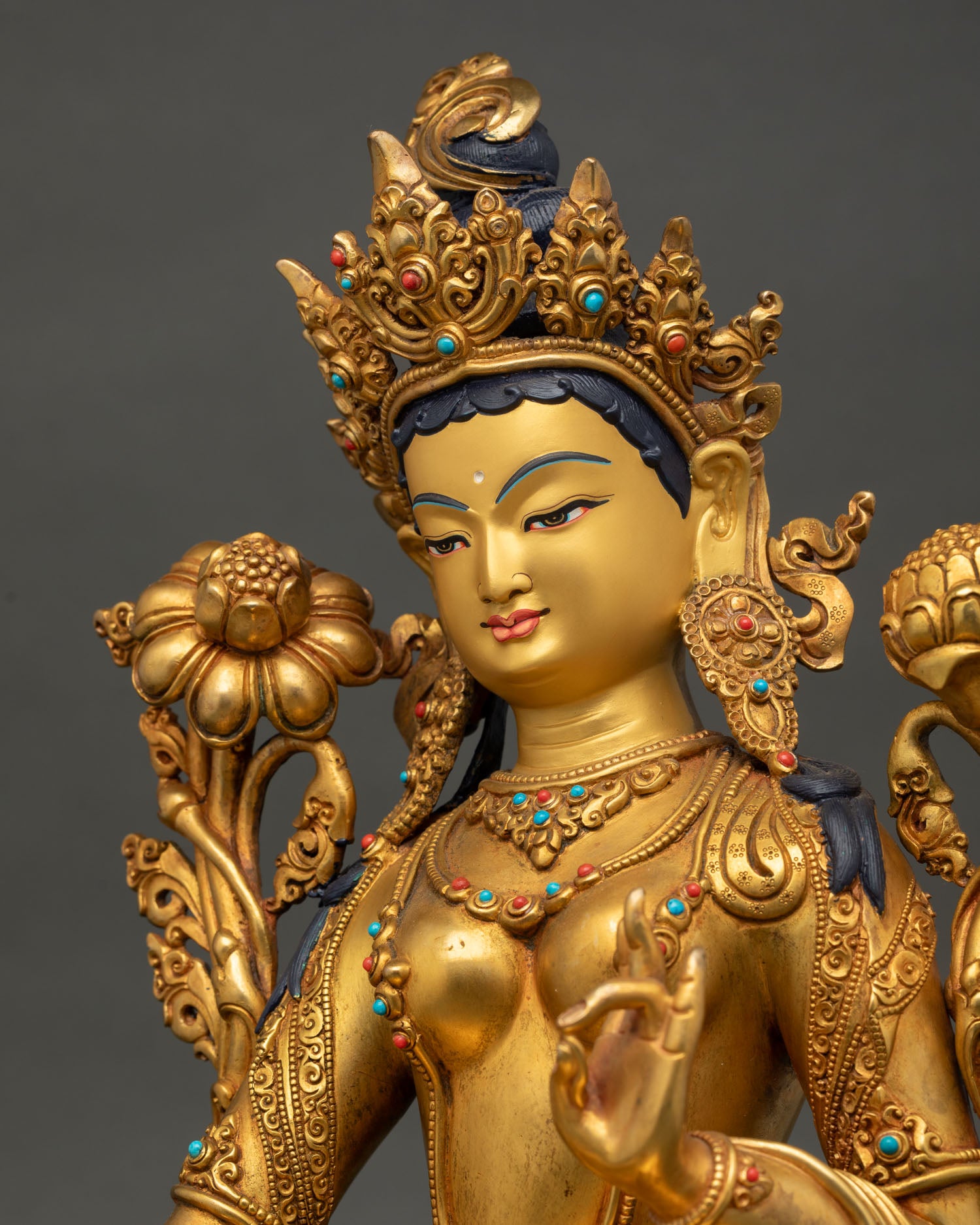 Detailed side close-up of Green Tara Statue with lotus and ornate jewelry