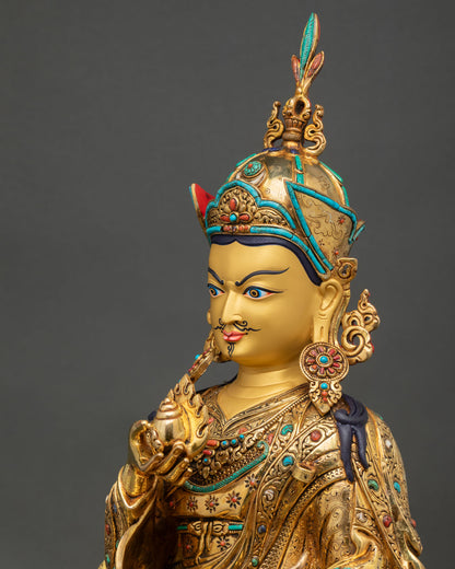 detailed side close up of guru orgyen norlha statue with ornate crown, jewelry, and vajrayana carvings