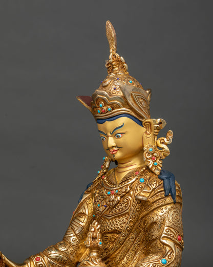 Detailed side close up of Guru Rinpoche statue showing engraved floral robe and turquoise coral inlays