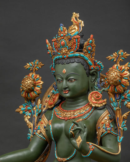Detailed side close up of handcrafted copper Green Tara statue showing utpala flowers