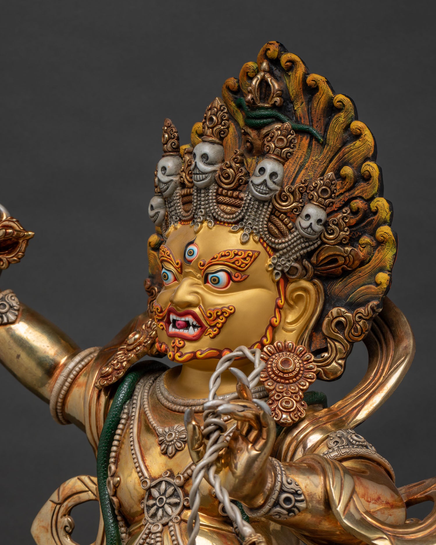 Detailed side close-up of handmade Vajrapani statue, gold-gilded copper craftsmanship