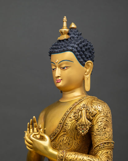 Detailed side close up of Maitreya Buddha statue showing hand-chased Kasaya robe and teaching gesture