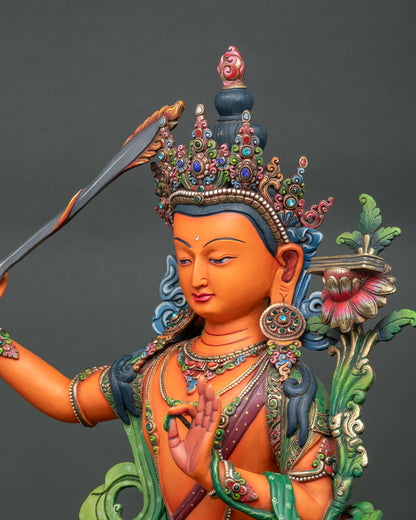 Detailed side close up of Manjushri statue with intricate crown and jewelry