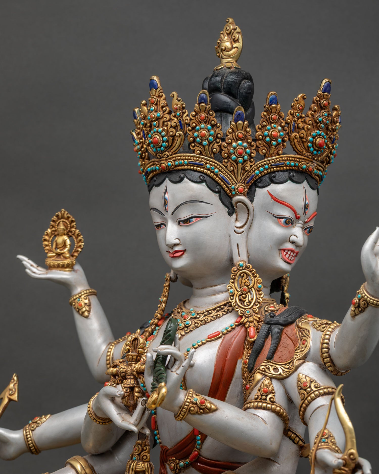 detailed side close up of namgyalma statue showing sacred implements and ornate craftsmanship