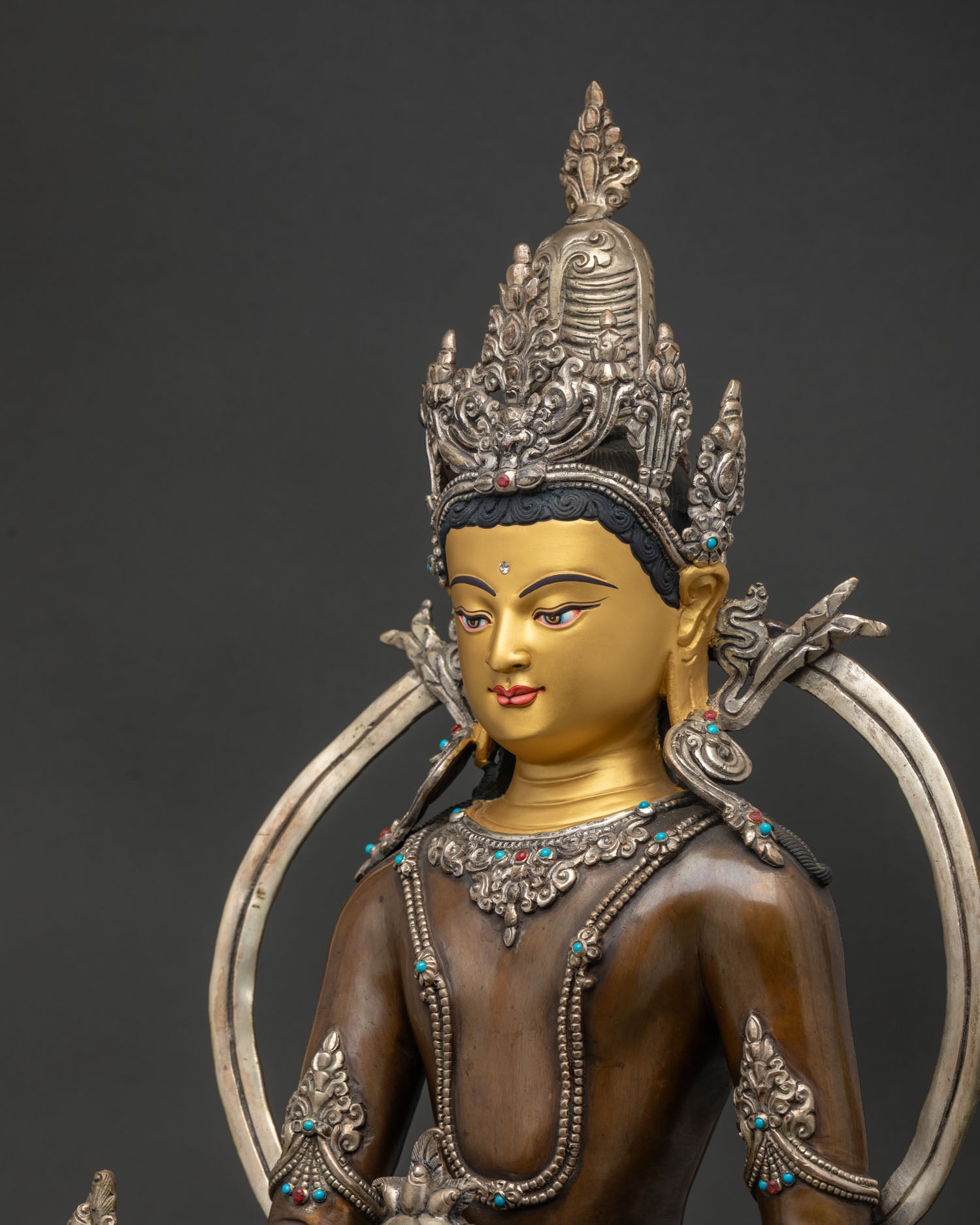 Detailed side close up of Oxidized Medicine Buddha Statue with coral and turquoise ornaments