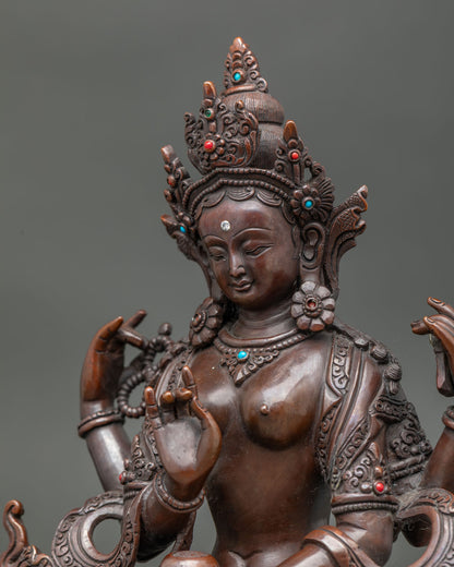 detailed side close up of oxidized prajnaparamita statue with stone inlay and carvings