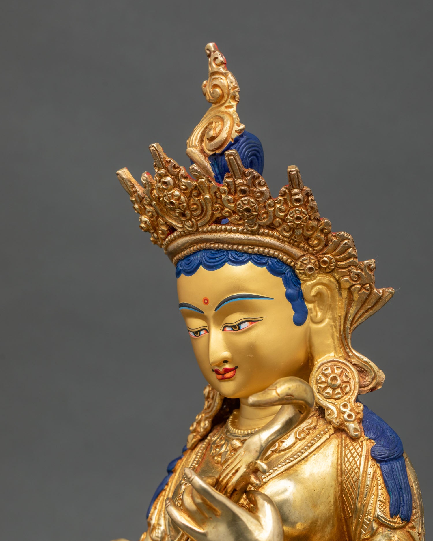 Detailed side close-up of Saraswati statue showing lotus throne and ornaments