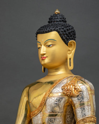 Detailed side close up of Shakyamuni Buddha statue with hand-chased silver robe and repoussé work