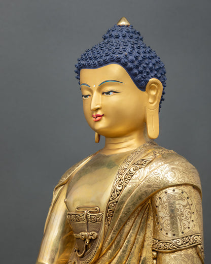detailed side close-up of shakyamuni buddha statue with lotus base and robe engravings