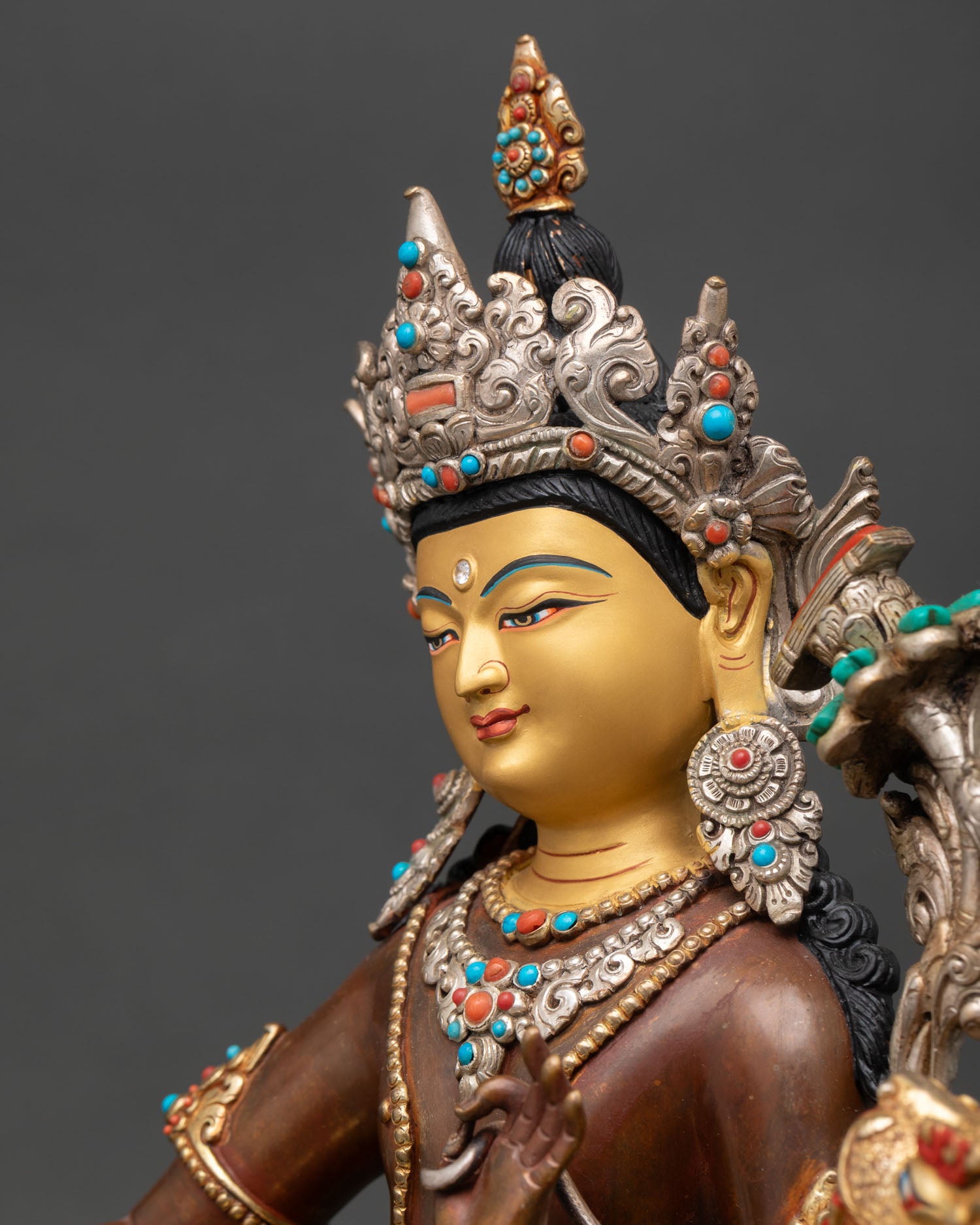 detailed side close up of simhanada manjushri statue with silver plated ornaments