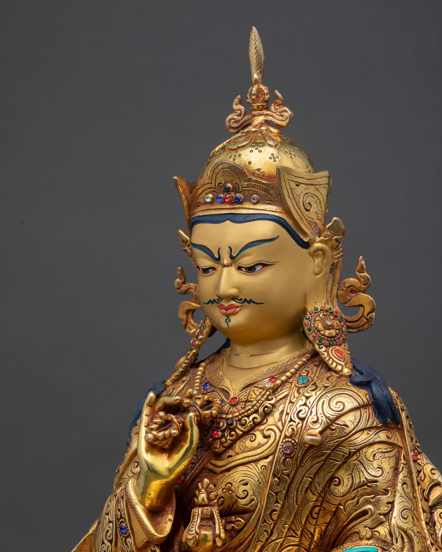 detailed side close up of tsokye dorje statue with intricate robe and ornament work