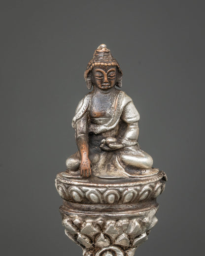 Detailed side close-up of Ucchusma statue showing silver-plated wheel, spear and ritual implements