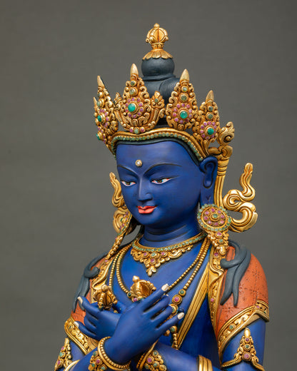 Detailed side close up of Vajradhara Statue with gold gilded robe patterns