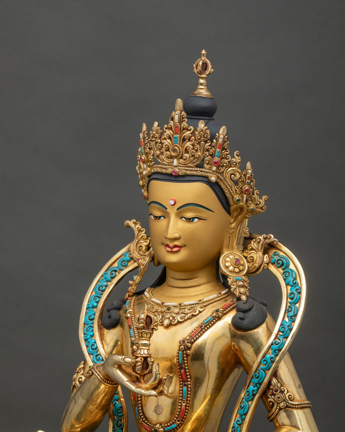 Detailed side close up of Vajrasattva statue with 24K gold gilding and semi-precious inlays