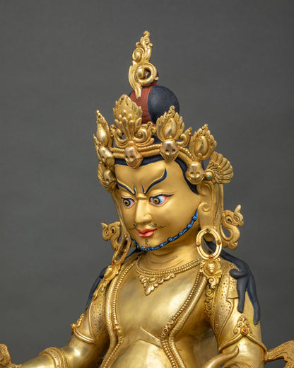 Detailed side close up of Yellow Dzambhala statue with engraved royal garment and jeweled ornaments