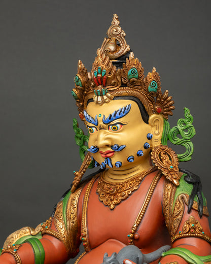 detailed side close up of yellow dzambhala statue with gemstone inlays and traditional nepalese craftsmanship