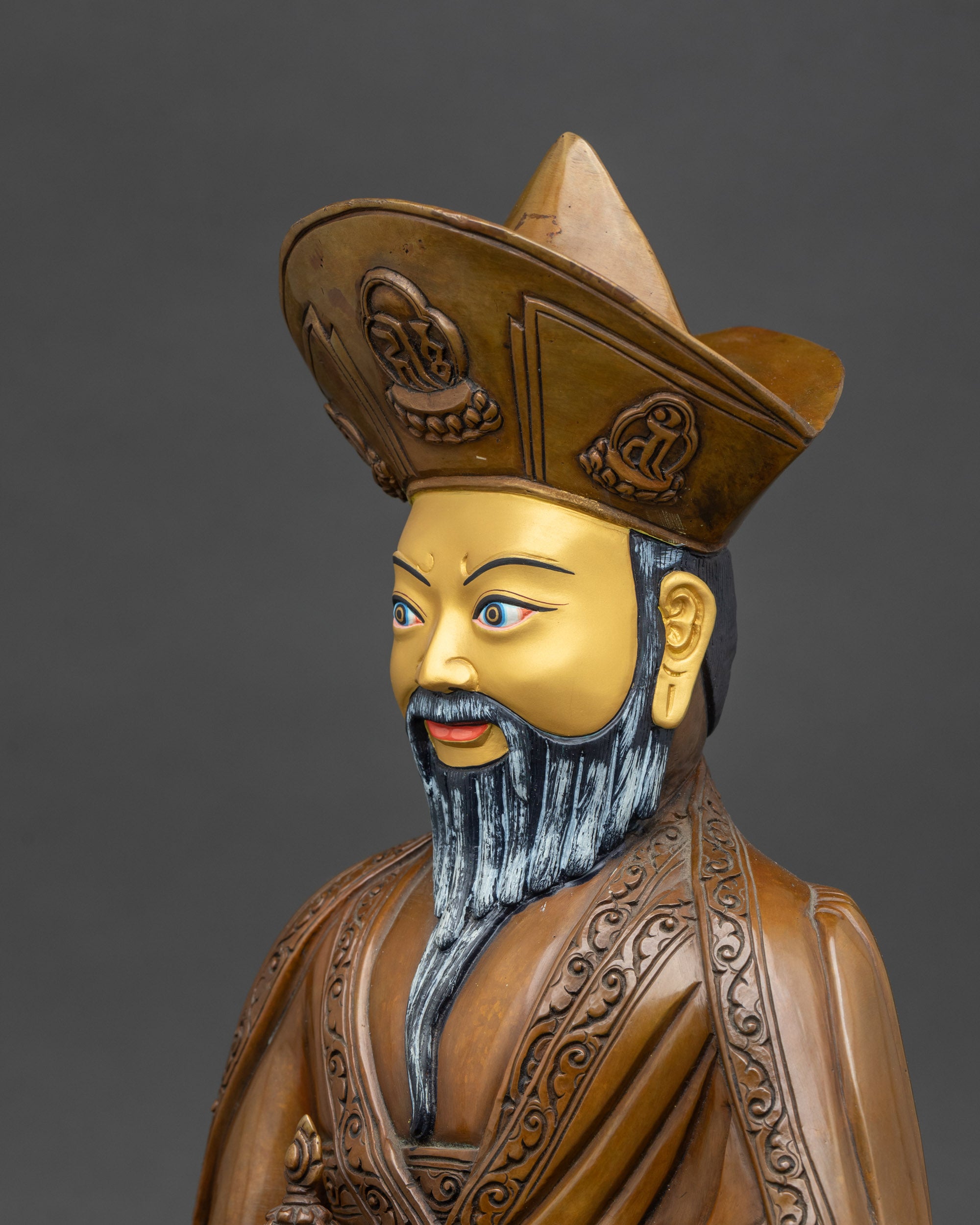 Detailed side close-up of zhabdrung rinpoche statue, showcasing copper craftsmanship and oxidized finish