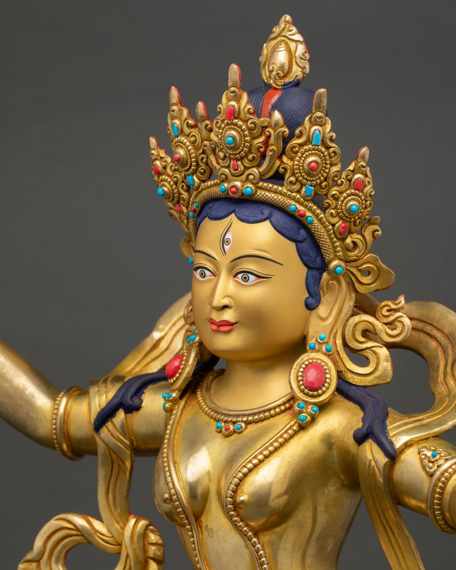 detailed side close up, side detail of machig labdron statue showing garments, repoussé carving and gold gilded ornaments