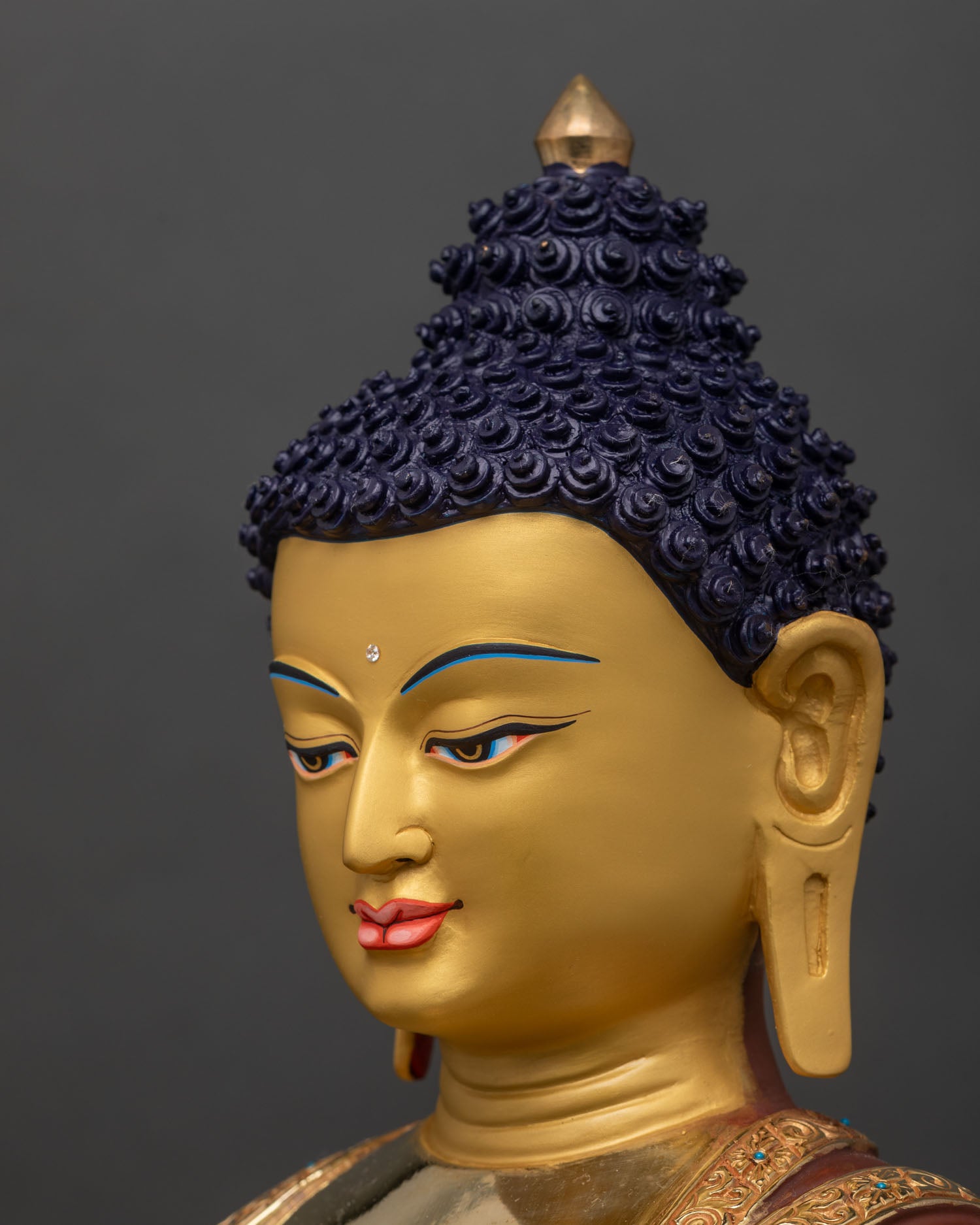 detailed side face of Shakyamuni Buddha statue with calm expression and gold details