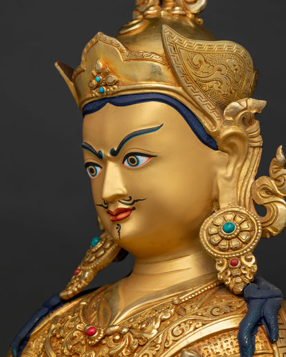Detailed side profile of Padmasambhava statue face showing fine 24K gold gilding craftsmanship.