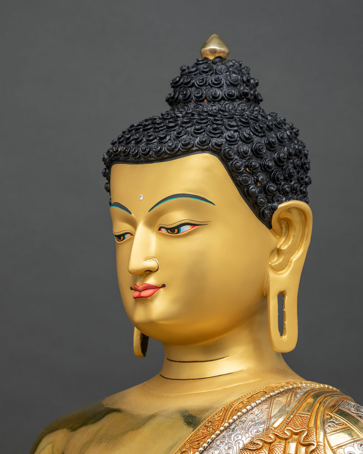 Detailed side profile of Shakyamuni Buddha statue face with elongated ears and serene expression