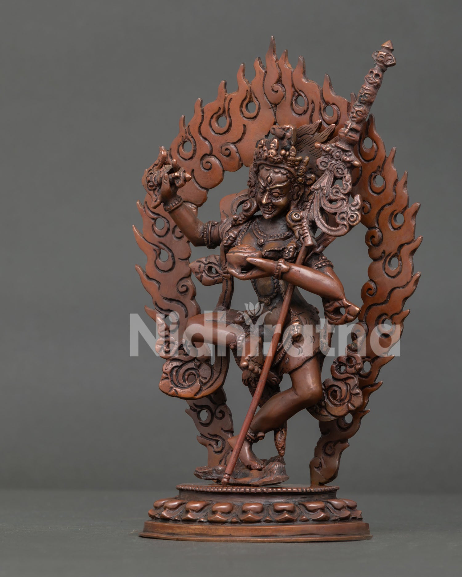 Detailed side view of Dorje Phagmo Buddhist sculpture with khatvanga staff and sacred ornaments.