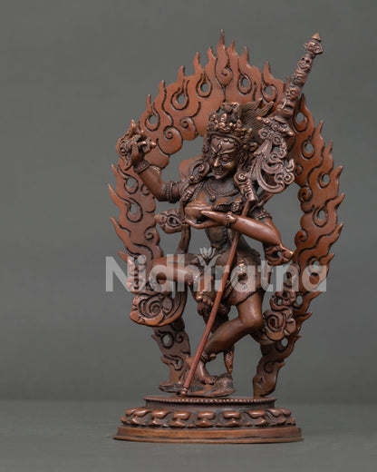 Detailed side view of Dorje Phagmo Buddhist sculpture with khatvanga staff and sacred ornaments.