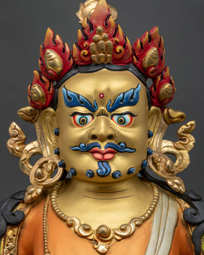 Detailed side view of Dzambhala statue showing intricate ornaments gold gilding