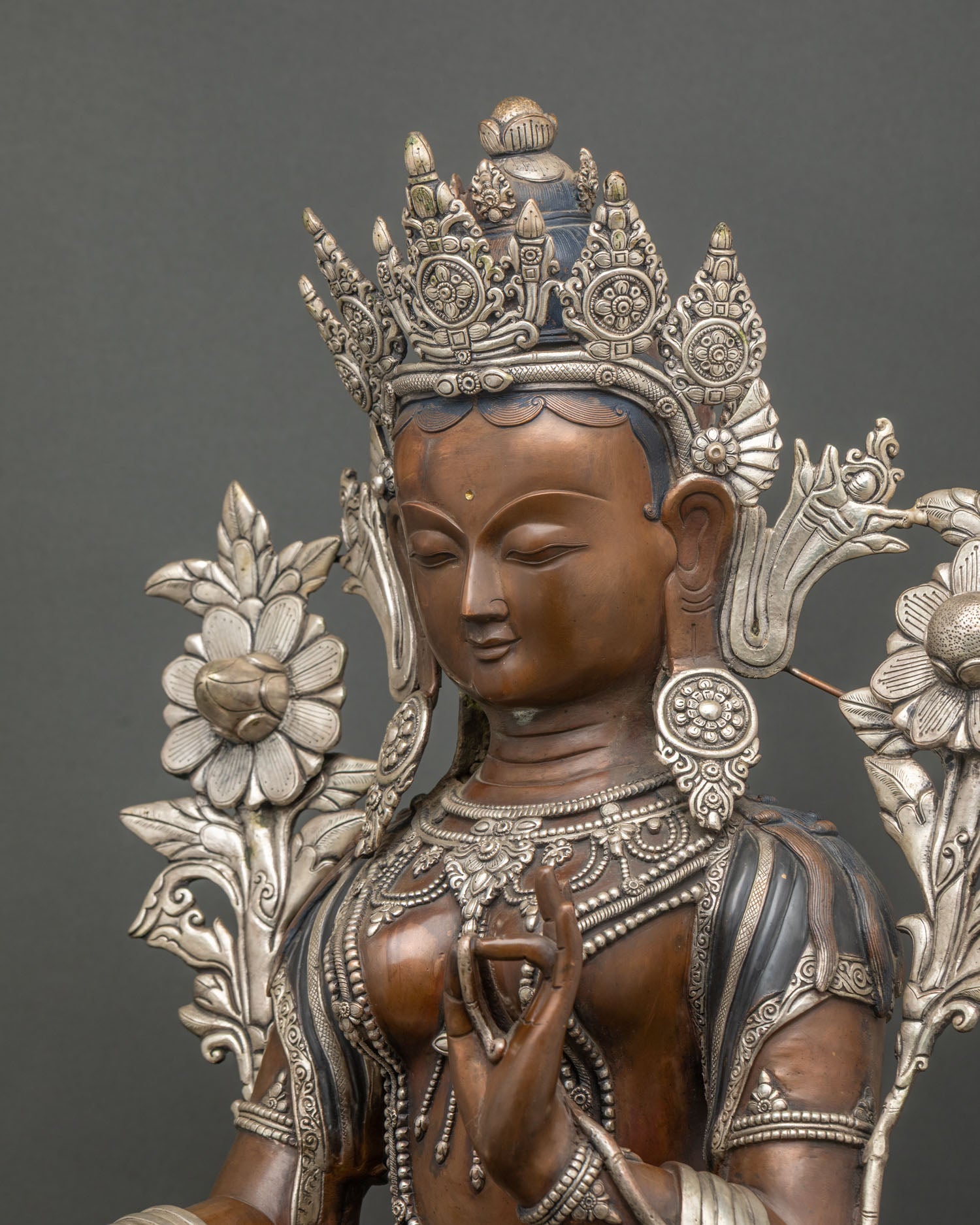 Detailed side view of Green Tara Statue highlighting silver ornaments and oxidized copper craftsmanship