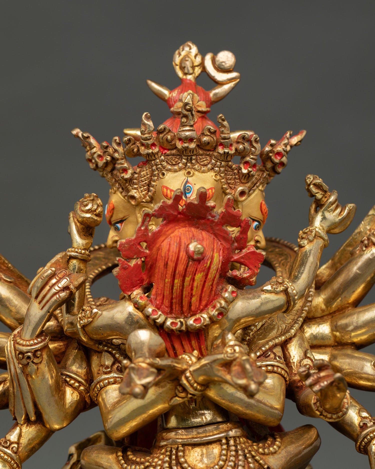 detailed side view of kalachakra statue with sacred ritual implements