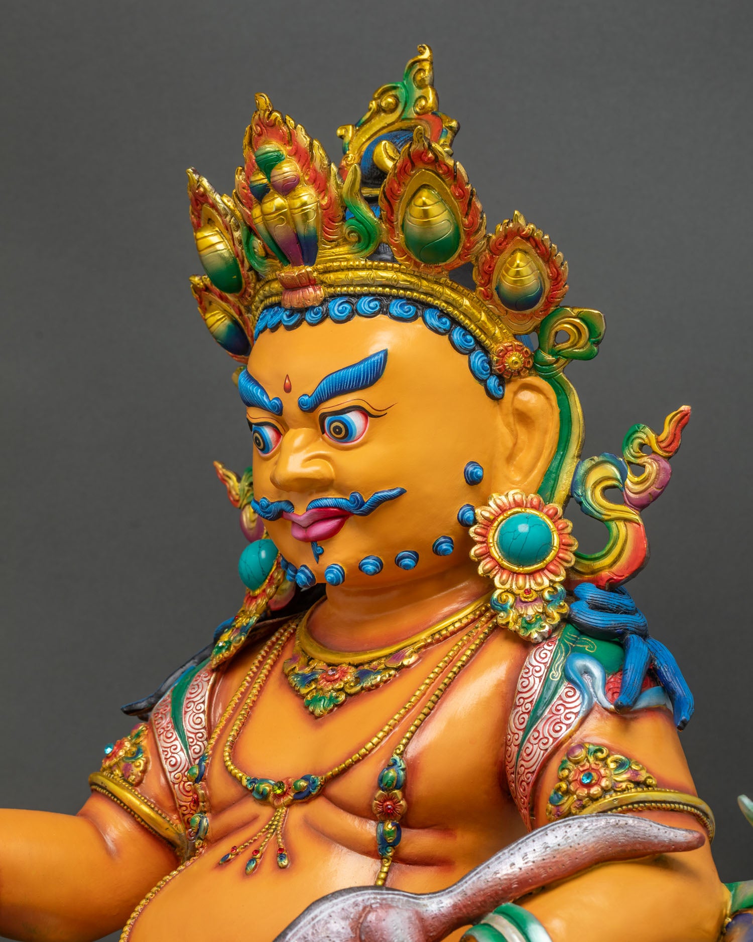 Detailed Side View of Yellow Dzambhala Statue Showing Mongoose Jewelry and Lotus Throne
