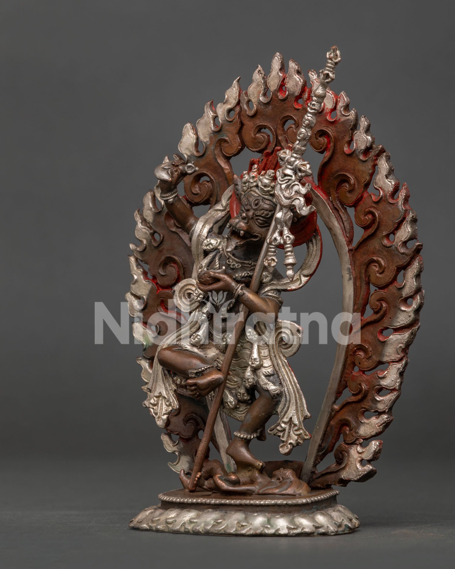 Detailed Simha Mukha statue with lion face crown flaming hair and skull garland.