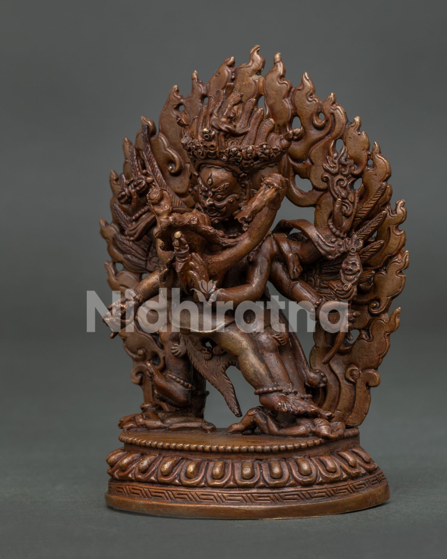 Detailed Vajrakilaya statue showcasing the sacred phurba, four arms, intricately carved wings, and a radiant blazing halo.