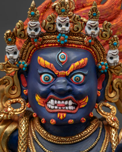 Detailed Vajrapani statue face with fierce expression, skull crown, and gold gilding