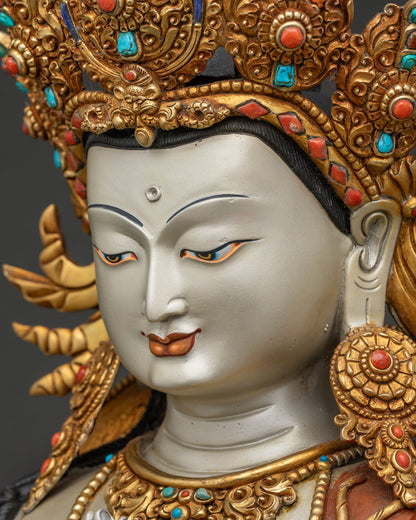 Detailed view of Avalokiteshvara statue's serene expression and jeweled crown with turquoise stones