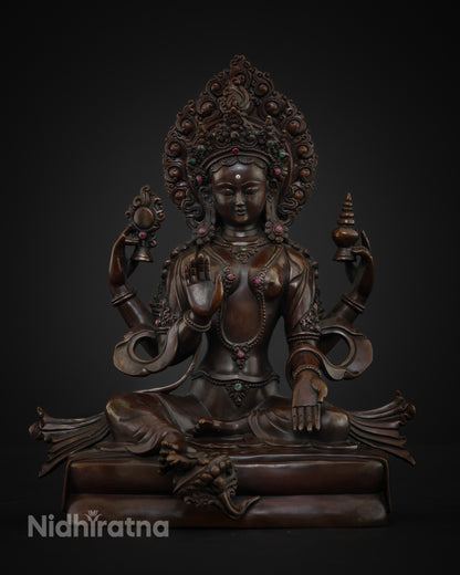 Detailed view of Goddess Lakshmi, with a flaming halo adorned with gemstone inlays and ornate scrollwork craftsmanship