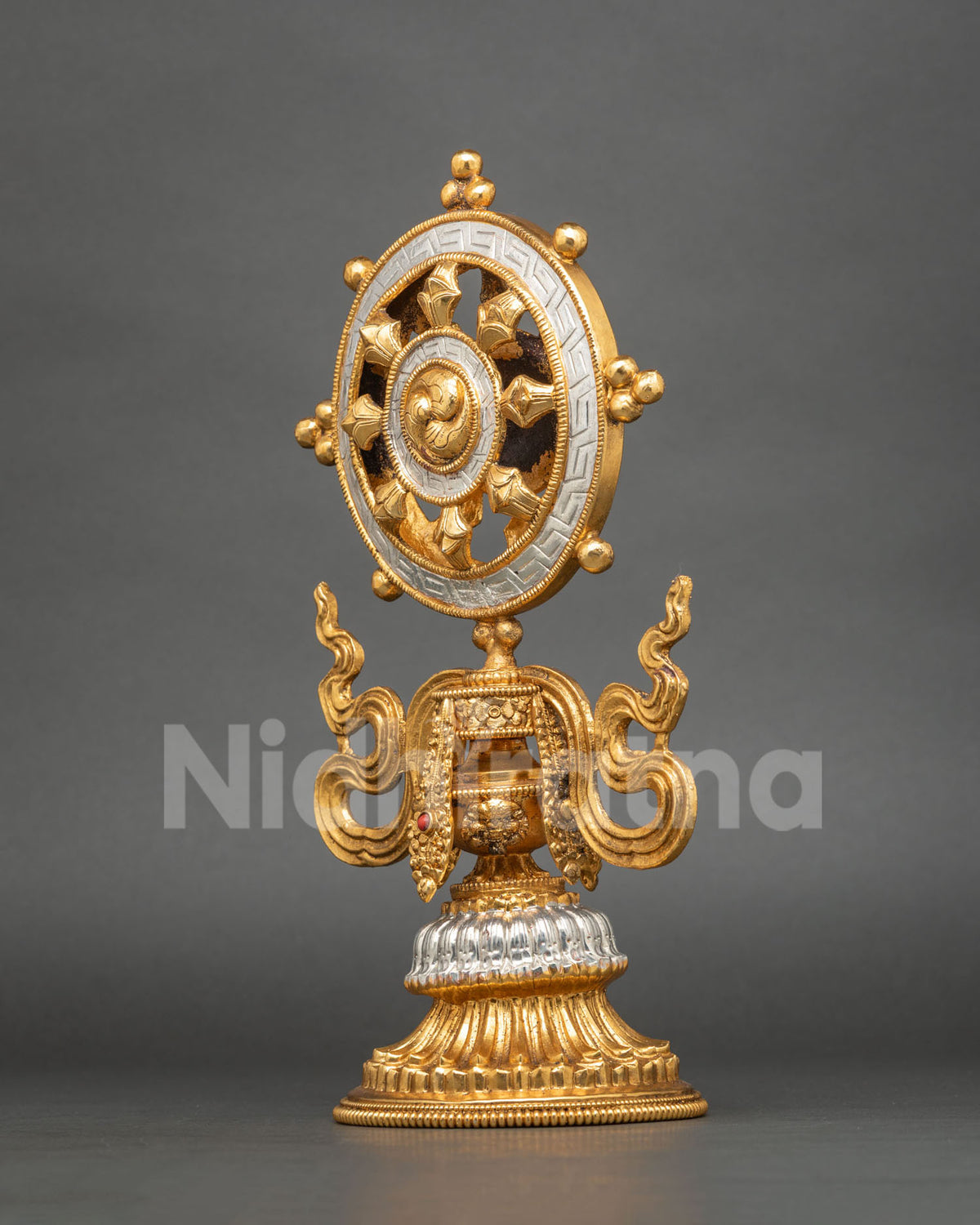 Detailed view of gold and silver-plated Buddhist Dharma Wheel handcrafted in Patan, Nepal