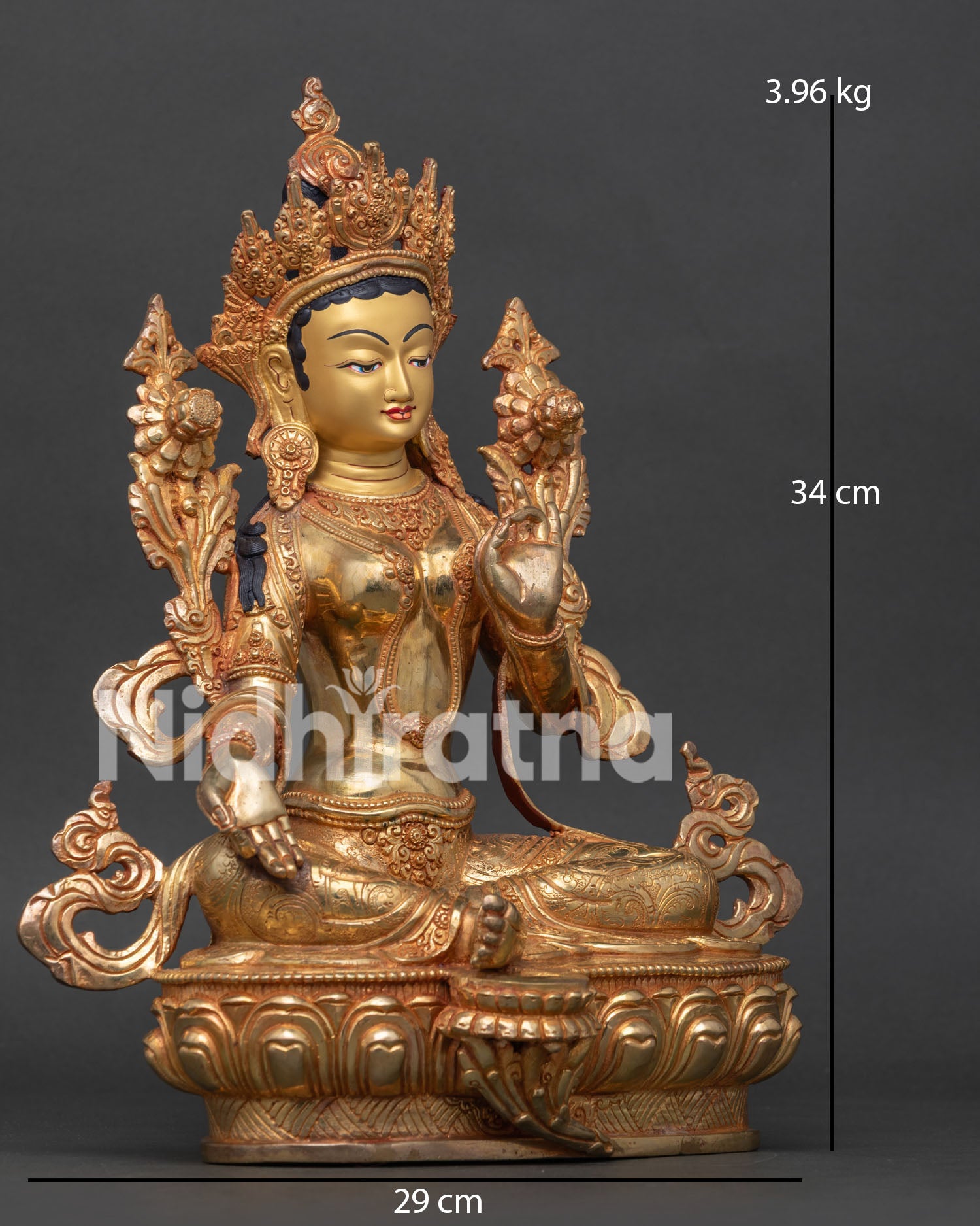 Detailed view of Green Tara holding blue Utpala lotus with royal ease posture and blessing mudra