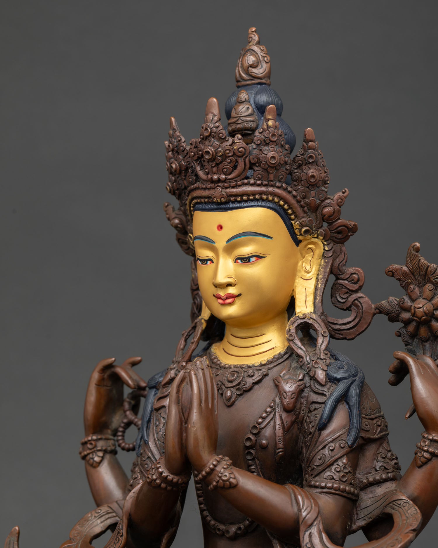 Detailed view of Vajrasattva Buddhist sculpture with sacred ornaments and traditional Himalayan artistry.