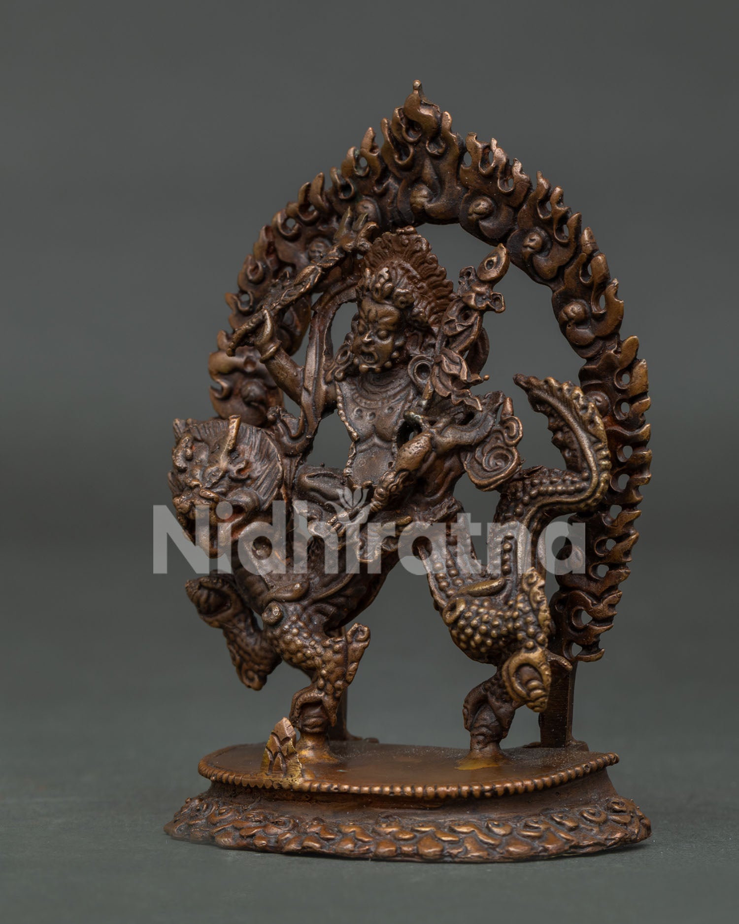 Detailed White Dzambhala statue with oxidized copper finish and dragon.