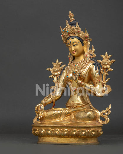 Detailed White Tara Statue seated on lotus pedestal with flowing robes and sacred symbolism.